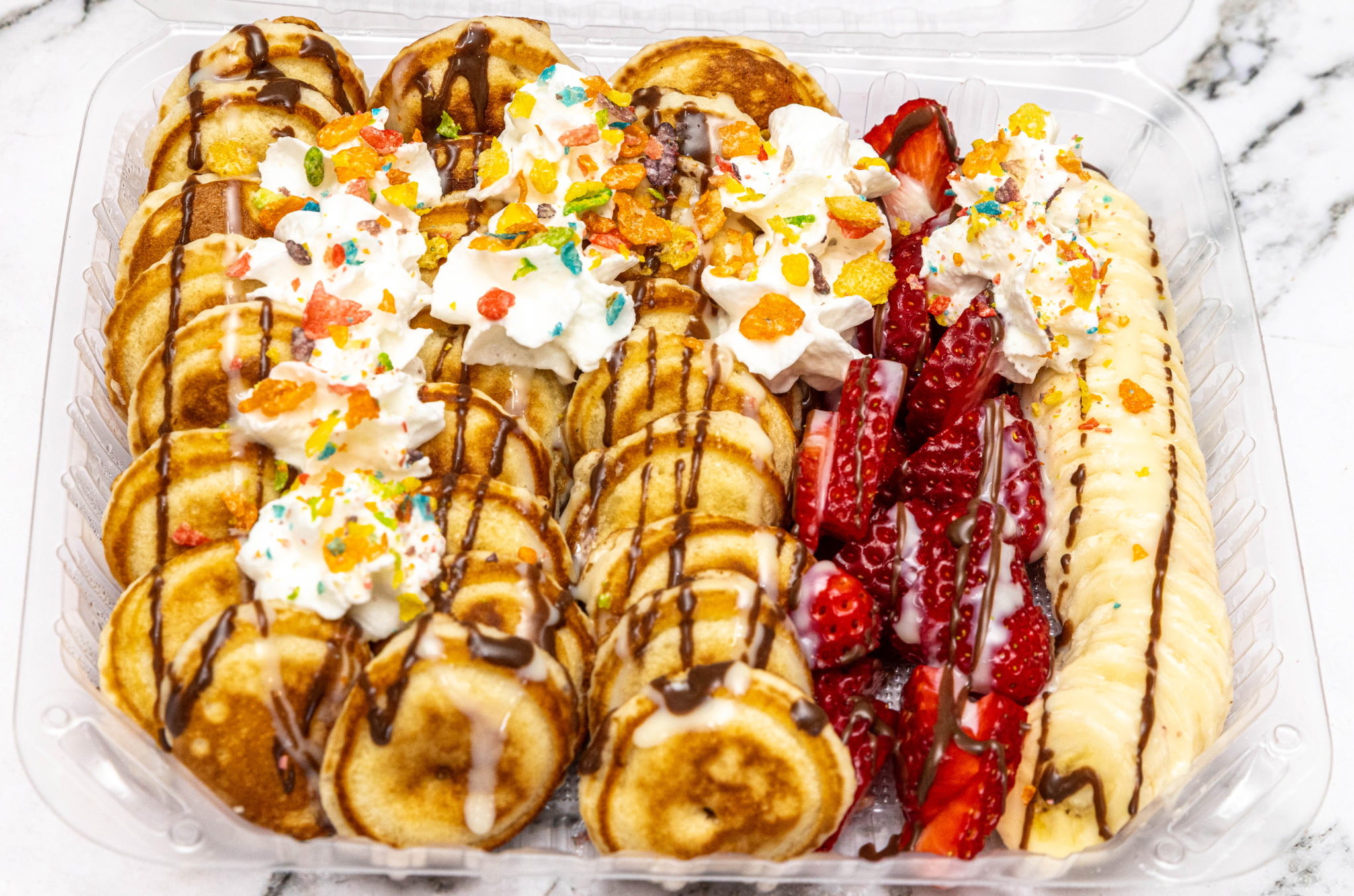 Mini pancake platter with strawberries and chocolate